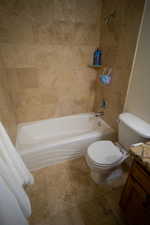 Full bath featuring shower / tub combination, vanity, and tile patterned floors