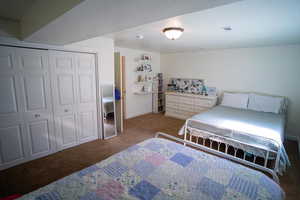 Carpeted bedroom featuring a closet and baseboards