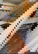 Laundry room with cabinet space, independent washer and dryer, and a textured ceiling