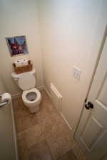 Bathroom with toilet and baseboards