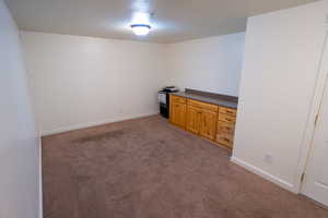 Empty room with baseboards and light carpet