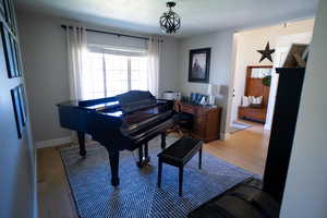 Sitting room featuring light wood-type flooring and a textured ceiling