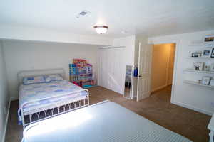Bedroom with carpet floors and a closet