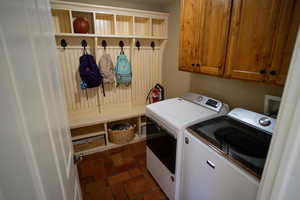 Laundry room with independent washer and dryer and cabinet space