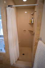 Bathroom with curtained shower
