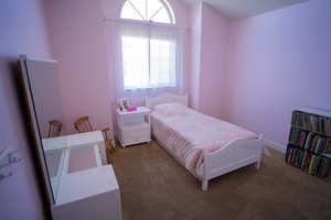 Bedroom featuring light colored carpet and baseboards