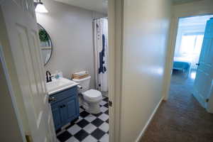 Bathroom featuring vanity, tile patterned floors, and curtained shower