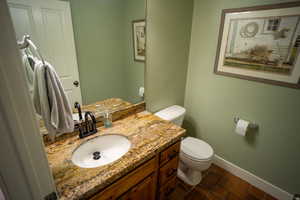 Half bath featuring vanity and tile patterned floors
