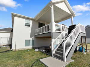View of property exterior featuring stucco siding and a deck