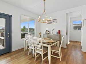 Dining room with a chandelier and light wood-style flooring