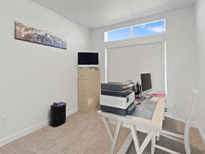 Office space featuring carpet floors and baseboards