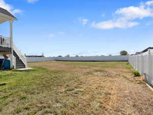 Fenced backyard with stairway