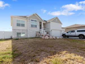 Craftsman-style house featuring board and batten siding and stone siding