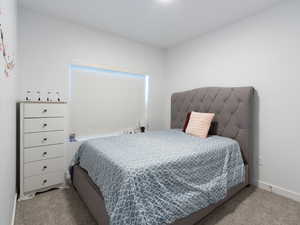 Carpeted bedroom featuring baseboards