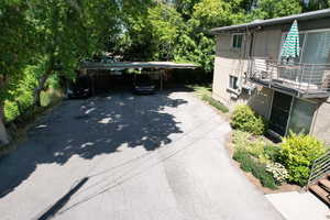 Patio / terrace with a detached carport and driveway