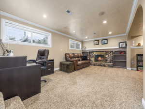 Carpeted family room featuring recessed lighting, a fireplace, and ornamental molding