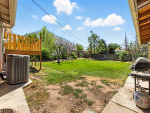 Fenced backyard featuring a mountain view