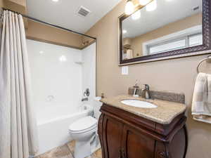 Bathroom featuring shower / bath combo and vanity