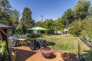 Fenced backyard featuring a vegetable garden