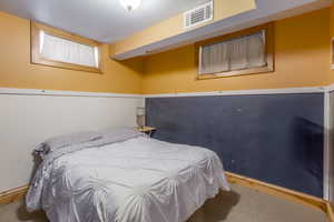 Bedroom featuring carpet and baseboards
