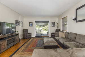 Living room featuring wood finished floors and healthy amount of natural light