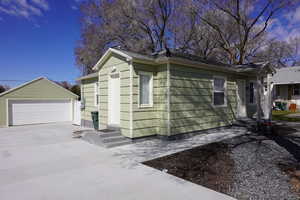 View of property exterior with a Detached Garage Conversion with front storage.
