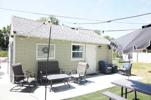 Back of property with a patio area and entrance to Great Room Garage Conversion
