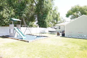 Fenced backyard with a playground