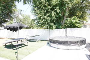 Fenced backyard featuring entertaining patio