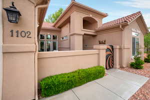 View of front of home featuring a tiled roof and stucco siding