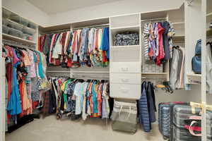 Walk in closet featuring carpet flooring