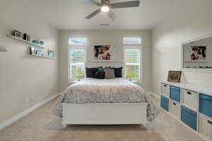 Bedroom with light colored carpet and ceiling fan