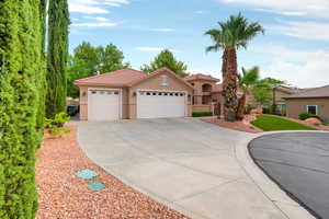 Mediterranean / spanish-style home featuring stucco siding, concrete driveway, an attached garage, and a tile roof