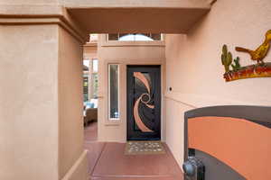 Property entrance featuring stucco siding