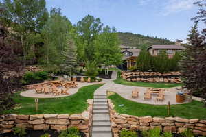 View of grassy yard with a patio and a mountain view