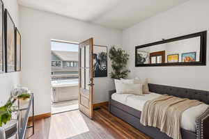 Bedroom featuring wood finished floors and baseboards