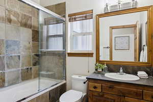 Full bathroom featuring tiled shower / bath combo and vanity