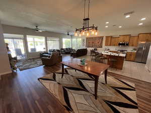 Dining room with a ceiling fan, recessed lighting, and light wood-type flooring
