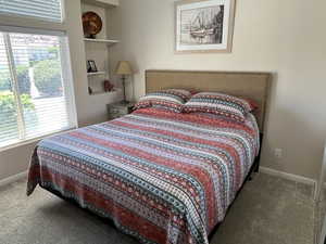 Bedroom with carpet floors and multiple windows