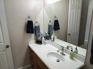 Bathroom featuring vanity and baseboards