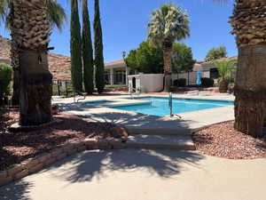 Community pool with a community hot tub and a patio