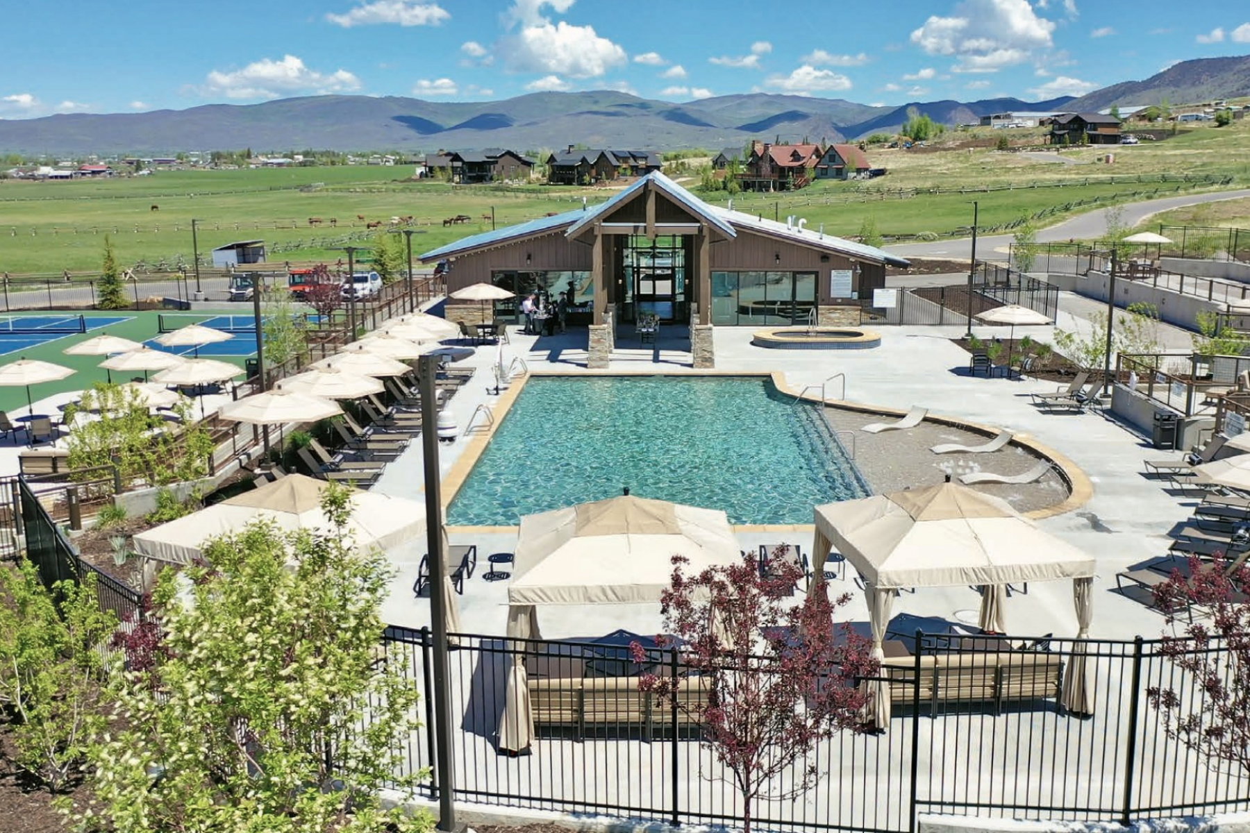 Community pool with a mountain view, a hot tub, and a patio area
