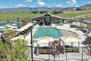 Community pool with a mountain view, a hot tub, and a patio area