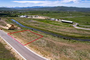 View of rural area with a water and mountain view and property parcel outlined