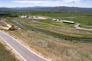 Aerial view of sparsely populated area with a water and mountain view