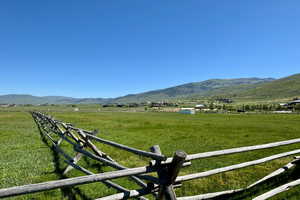 View of mountain backdrop with rural landscape and agricultural land