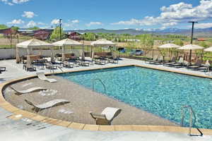Community pool with a gazebo, a mountain view, outdoor lounge area, and a patio area