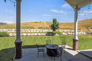 View of patio with an outdoor fire pit