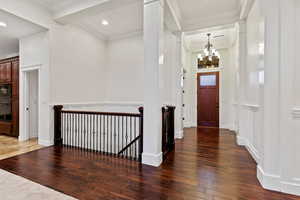 Foyer featuring dark wood-style floors, crown molding, a chandelier, and recessed lighting