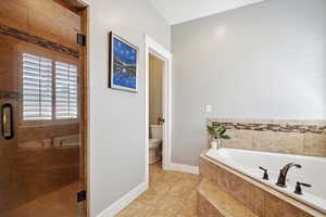 Full bath with a bath, a stall shower, and tile patterned flooring